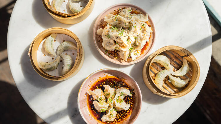 A table with bamboo baskets full of dumplings.