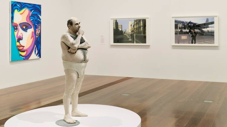 The sculpture of a man, two photographs and a painting in Who Are You: Australian Portraiture