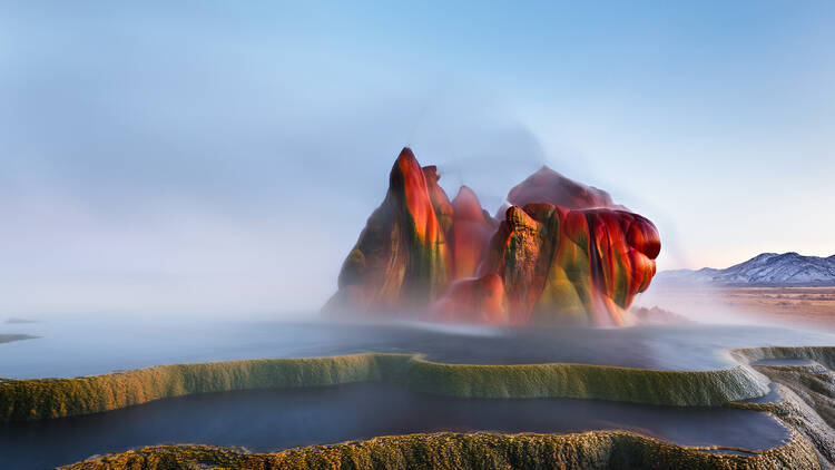 Fly Geyser near the Black Rock Desert in Nevada constantly erupts minerals and hot water creating bright colors and terraced pools.