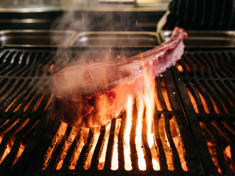 A tomahawk steak on a grill