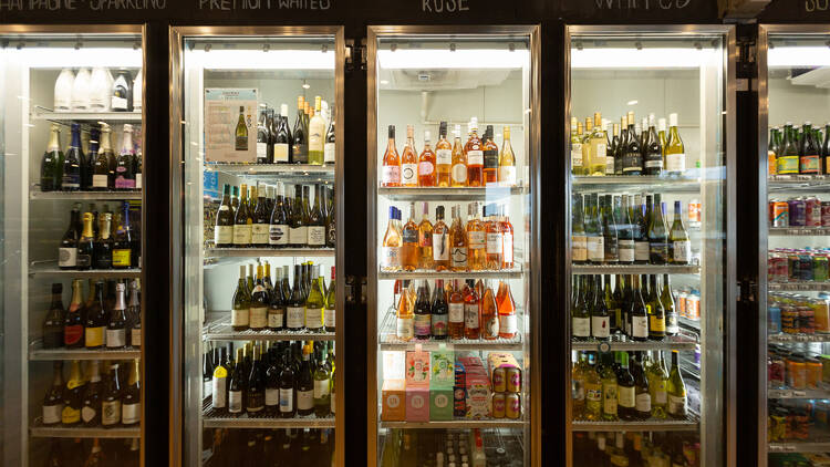 A fridge filled with wines.
