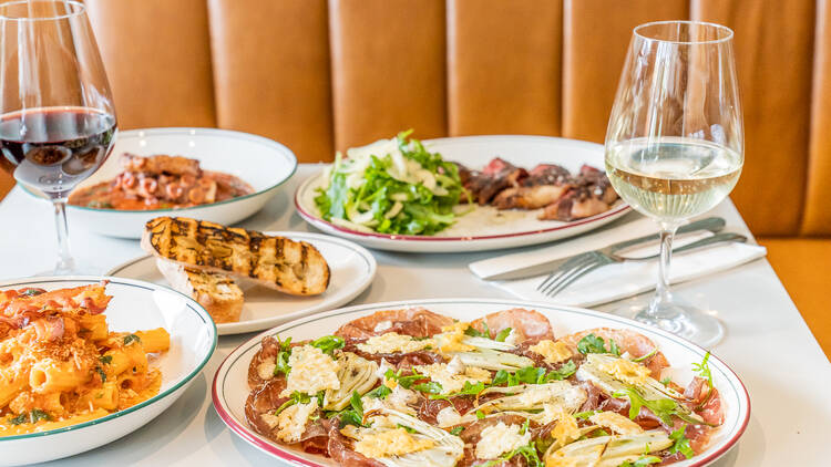 Charcuterie dishes and other Italian fare on a tabletop.