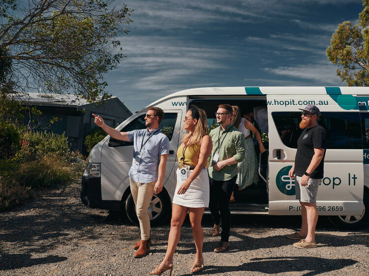 A group of people getting off of a Hop It van.