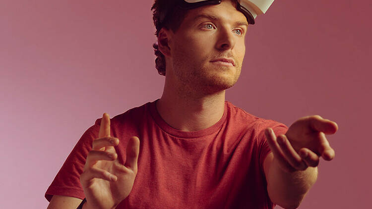 Oliver Coleman wearing a VR headset and a red T-shirt