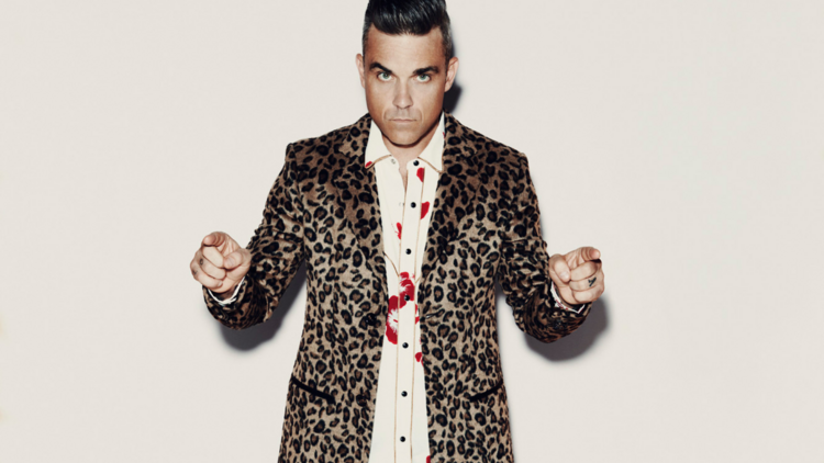 Singer Robbie Williams wearing a leopard print button up shirt and blood splattered shirt.