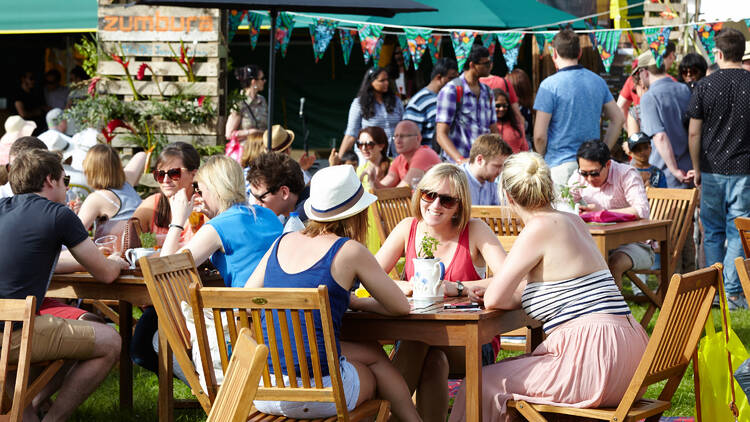 People sitting at tables in the sun