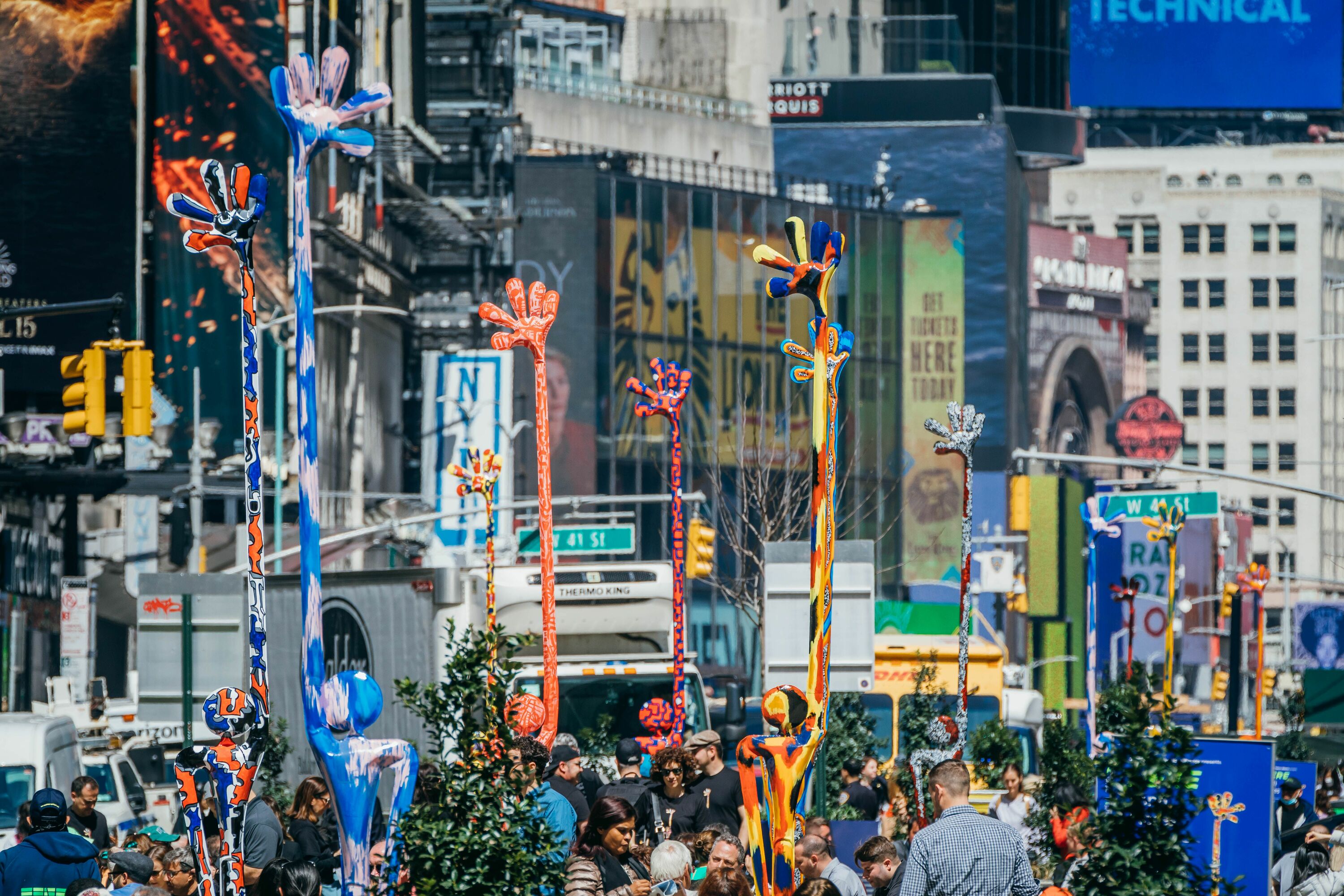 Gigantic sculptures are waving hello to New Yorkers on Broadway