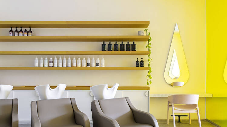 A seating area in a hair salon with places for shampooing.