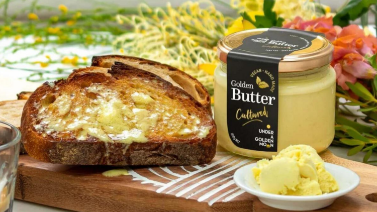 Vegan butter in a jar next to two slices of toast