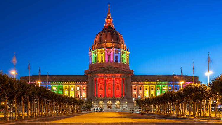 San Francisco City Hall illuminated in rainbow colors in honor of Pride Week.