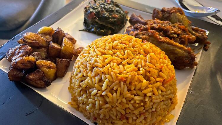 Vuuka Chicken Stew with Plaintains, Mixed Greens and Jollof Rice