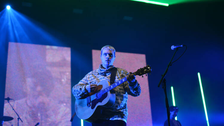 The guitarist of the DMA's on stage.