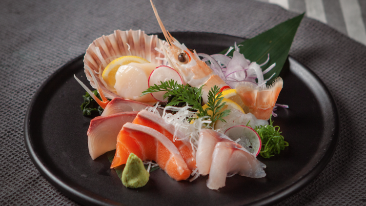 A platter of sashimi that includes kingfish, salmon, tuna and prawn.