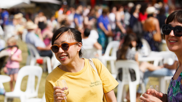 A person holds a wine glass at the Pyrmont Festival