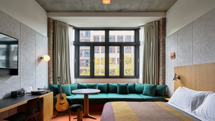 A suite with a green couch at the Ace Hotel