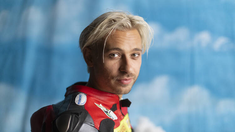 Musician/DJ Flume wearing a racing outfit.