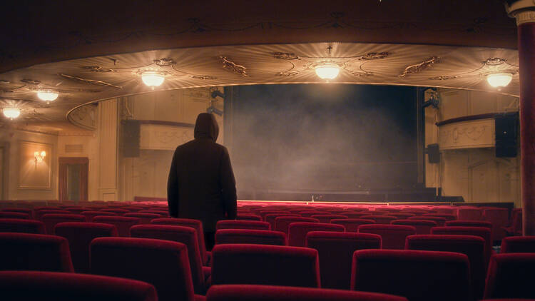 Ghost Stories a mysterious figure waits in a theatre