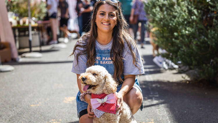 A woman and a dog outside.