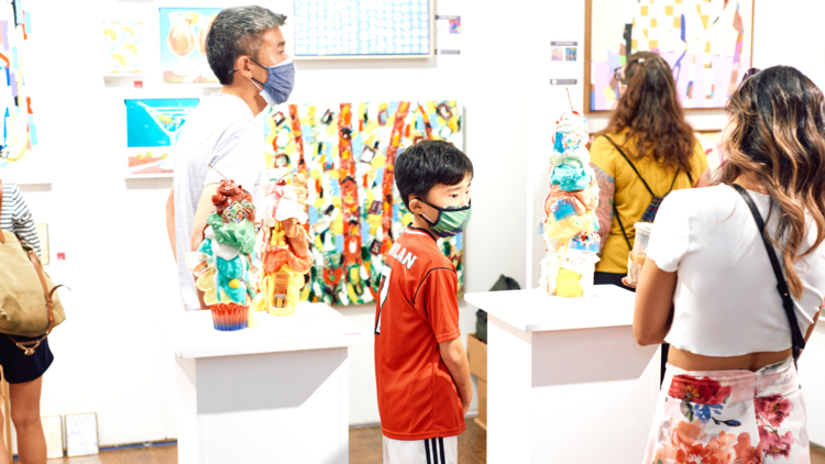 People shop for art at the Affordable Art Fair