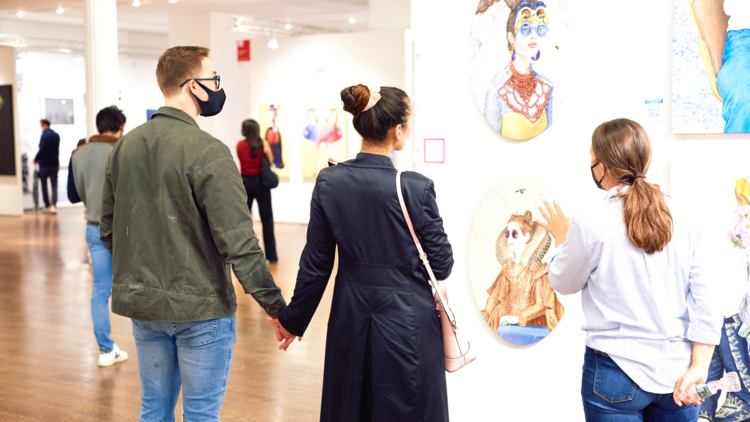 People shop for art at the Affordable Art Fair