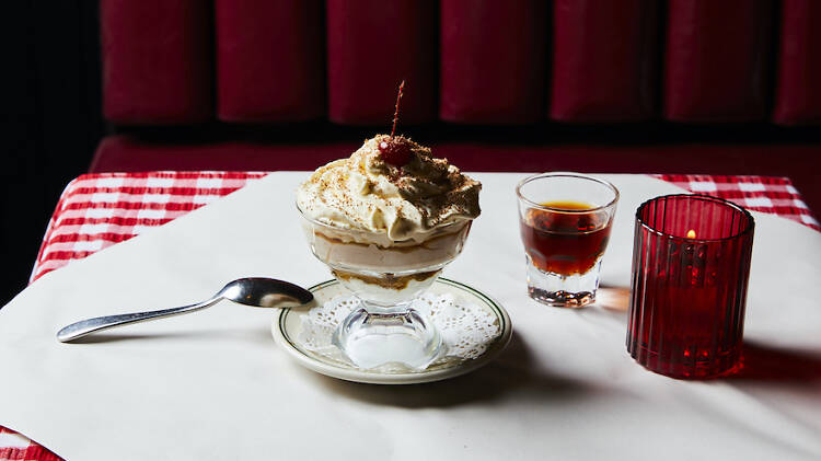 A sundae dessert on a table with a spoon