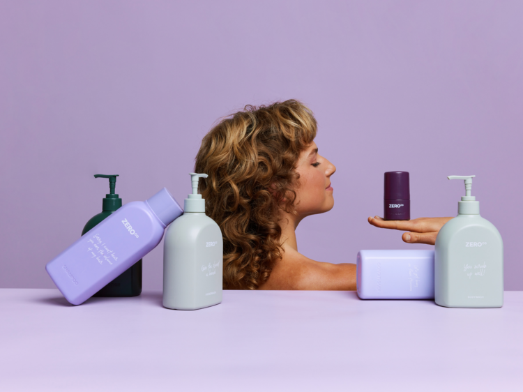 A woman in the background with heaps of eco-friendly body care products.