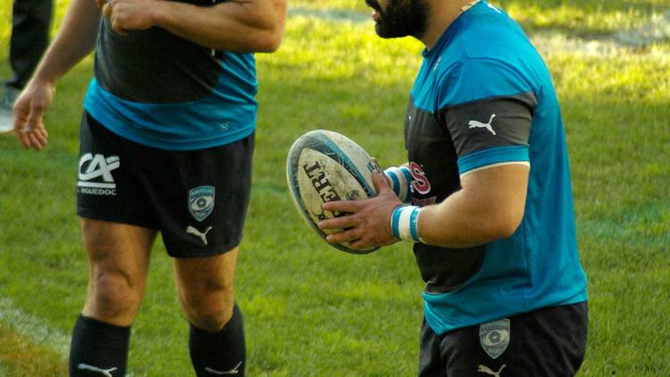 Two men on the NSW Blues rugby team on the field.