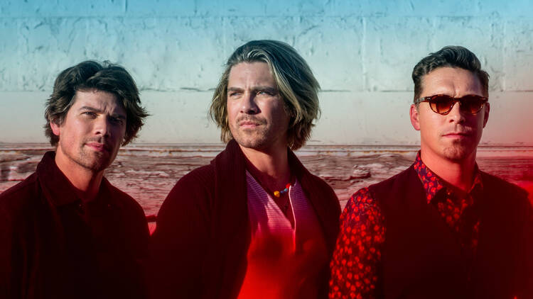 The three brothers comprising the band Hanson in a red, green and blue-tinted photo.