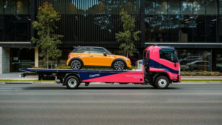 Delivery of a used car on the back of a tow truck