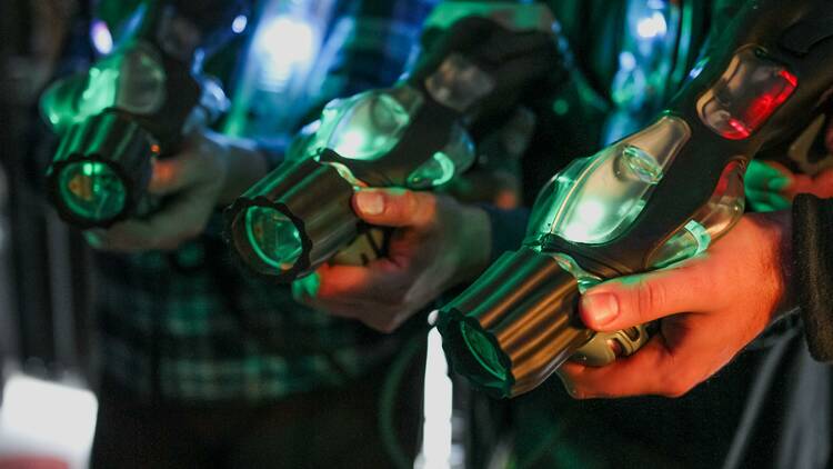 A group of friends equipped with laser tag guns.