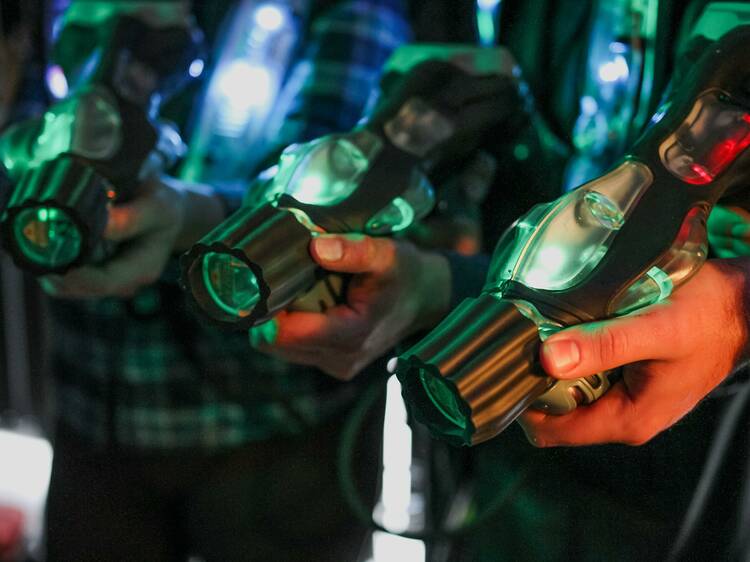 A group of friends equipped with laser tag guns.