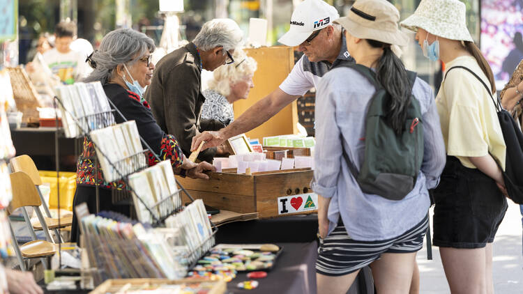 People peruse stalls at the arts centre market