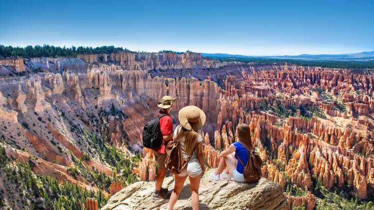 People on  hiking trip. Family on top of  mountain enjoying time together, looking at beautiful view. Inspiration Point, Bryce Canyon National Park, Utah, USA