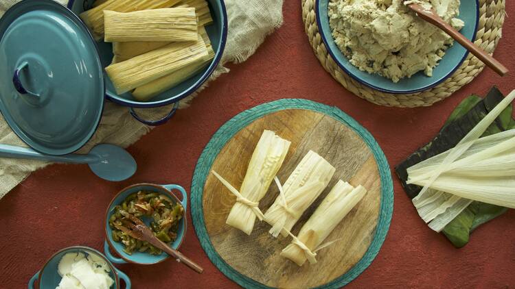 A table topped with supplies for making tamales.