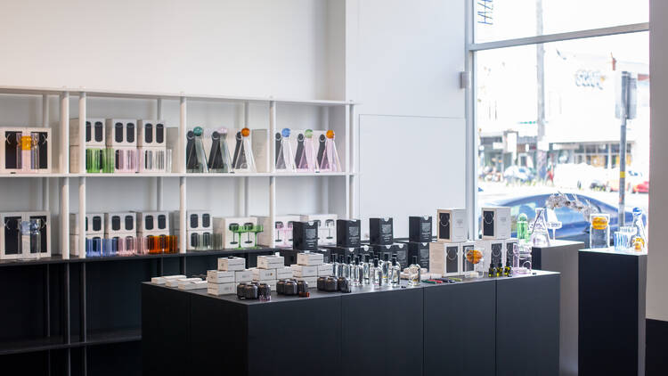 Interior store displays with candles and homewares.