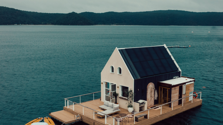 A floating luxury cottage sits on the water at Palm Beach