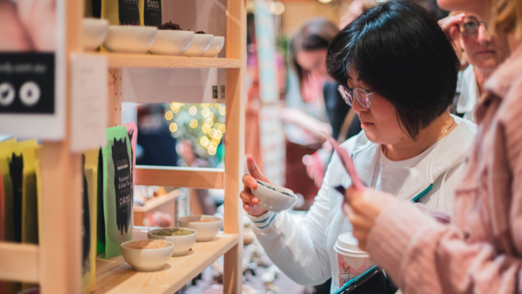 People picking up ceramic products at Sydney Made Art & Design Markets at Town Hall