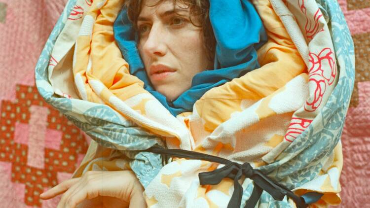Aldous Harding is wrapped in layers of colourful fabric