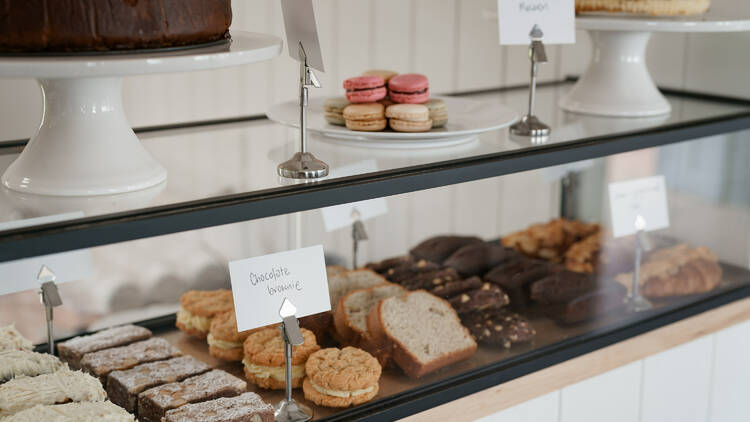 A baked goods display counter at Pier St Cafe.