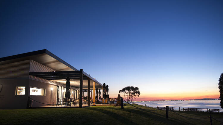 The sun setting near a winery and cellar door.