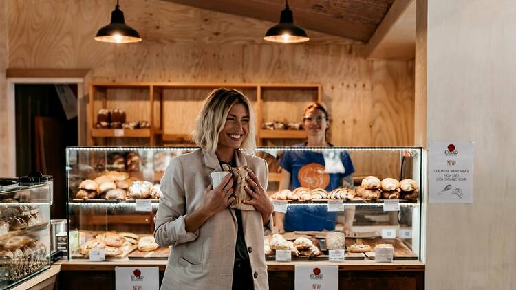 Head baker Miek serving a loaf to a customer.