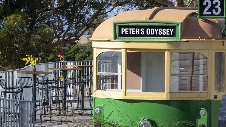 An old Melbourne tram that says Peter's Odyssey and has the number 23.