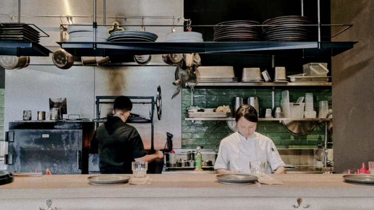 Two chefs working in a kitchen.