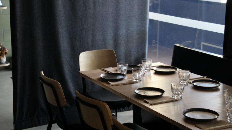 A dining table with six place settings.