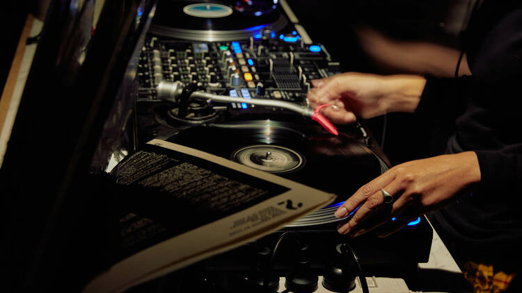 A DJ spinning vinyl records.