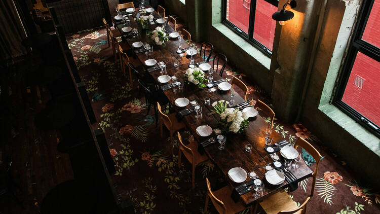 A long dining table with place settings.