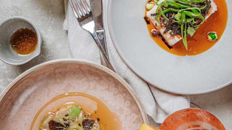 Flatlay of spiced tofu, kingfish sashimi, janh jim dressing and spritz