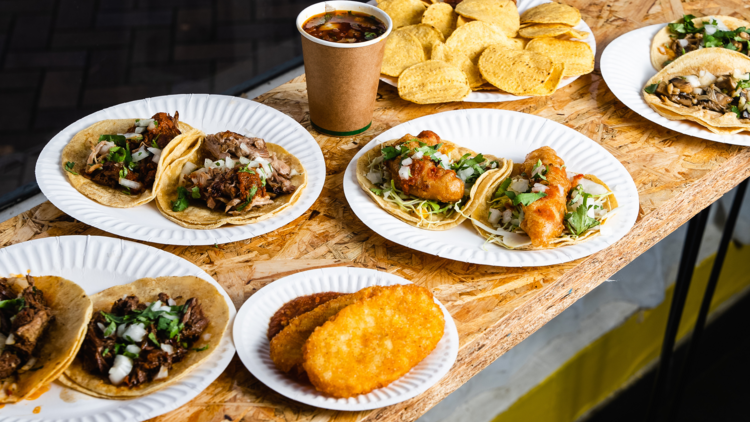 Flat lay of tacos on a raw wood table