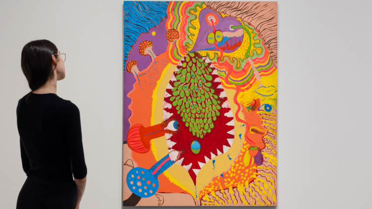 A woman stares at Vivienne Binns' bright and psychedelic  painting 