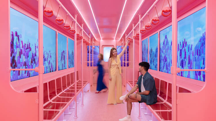 A pink recreation of a Chicago El train car at the Museum of Ice Cream Chicago